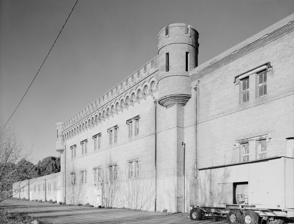Black-and-white Historic American Buildings Survey photograph of Building 1, showing crenellated parapet and a circular corner turret