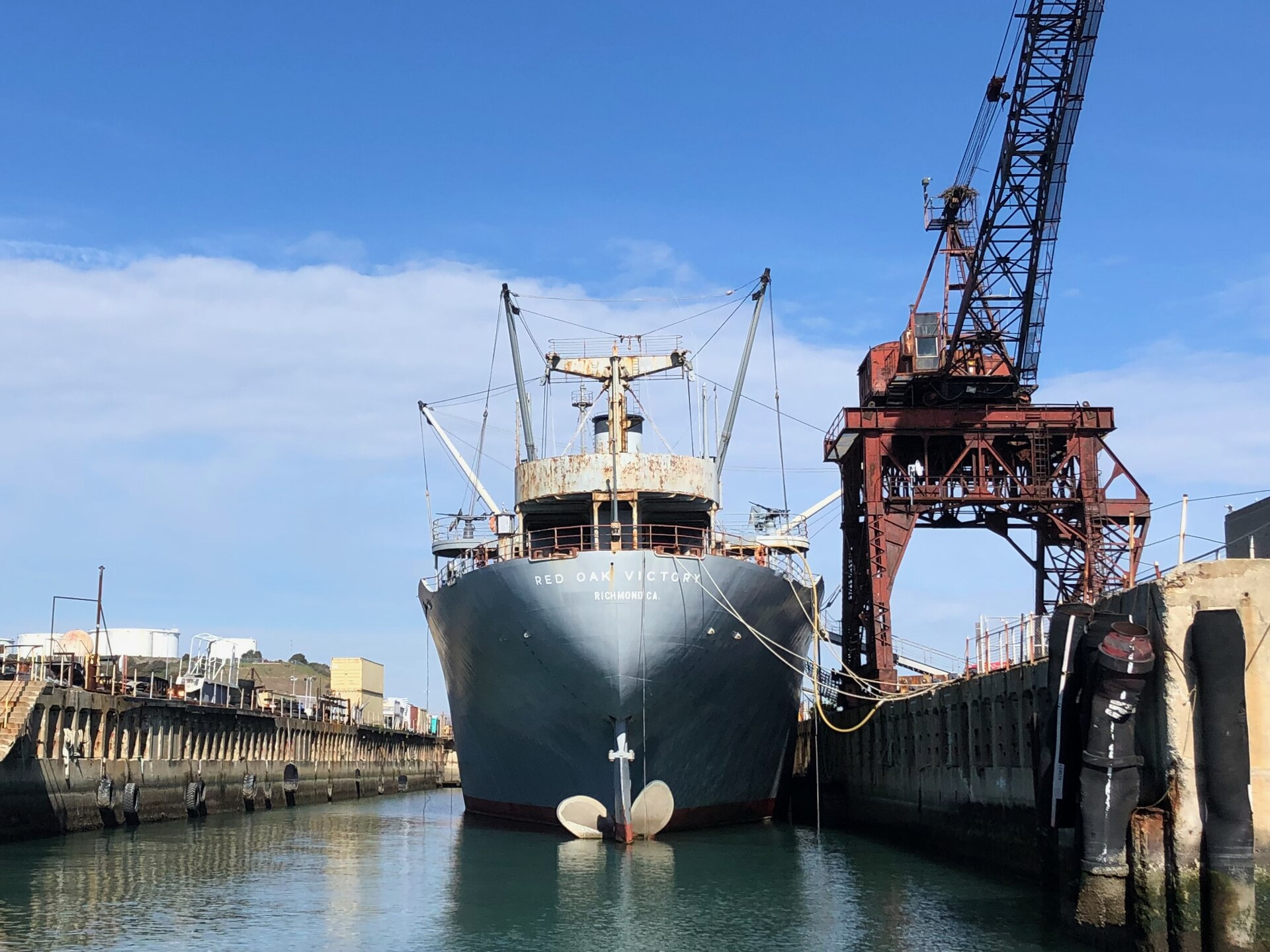 The SS Red Oak Victory in a graving basin with the whirley crane beside it at Shipyard No. 3